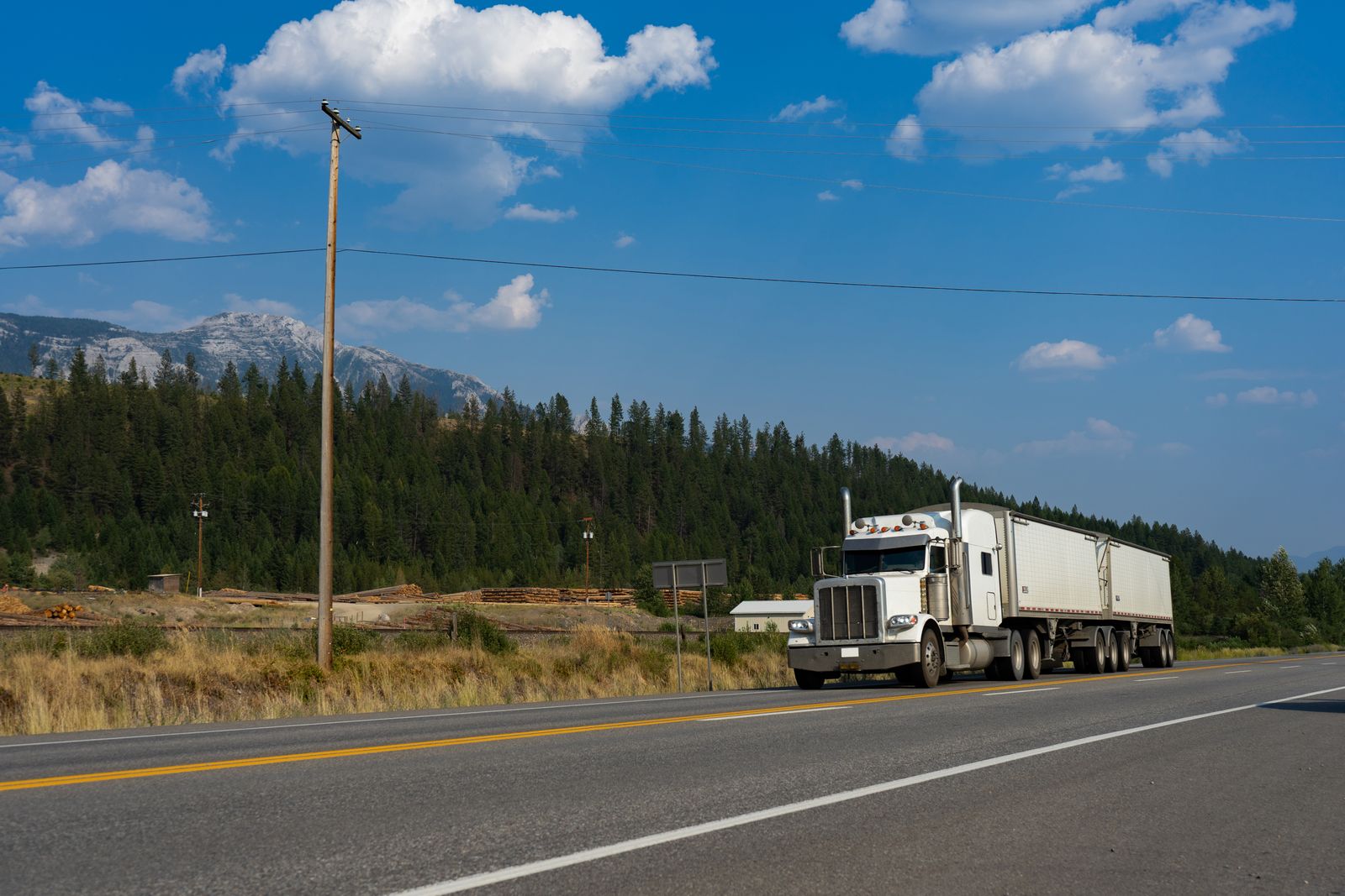 White semi truck traveling on a mountain highway