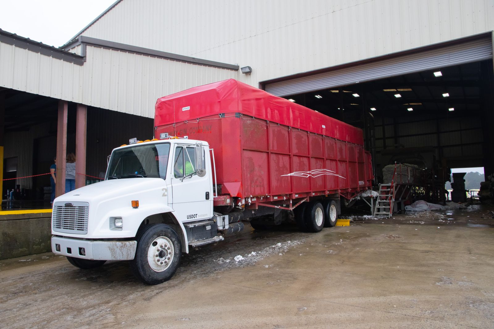 Commercial trailer positioned at an industrial loading facility